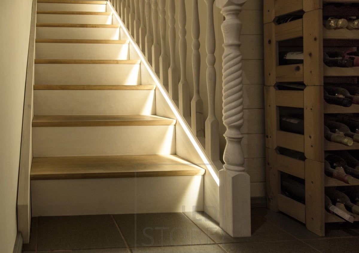 Led strip milled into the stair railing as close as possible to the step.